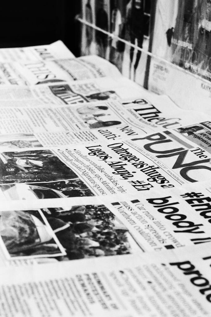 A detailed close-up of Nigerian newspapers in a monochrome format showcasing headlines and articles.